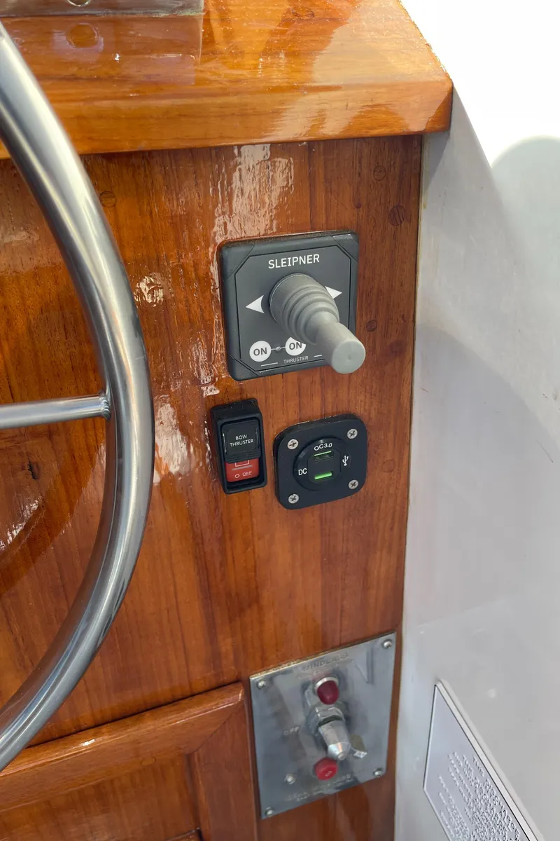 Slide: The Image of Control panel of a 1988 Ellis 28 boat with wooden finish and steering wheel. - 27