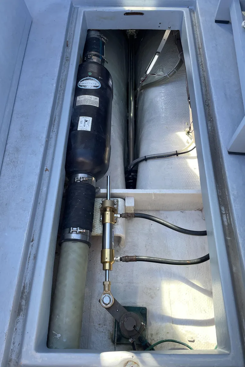 Slide: The Image of Engine compartment of a 1988 Ellis 28 boat, showcasing mechanical components and piping. - 30