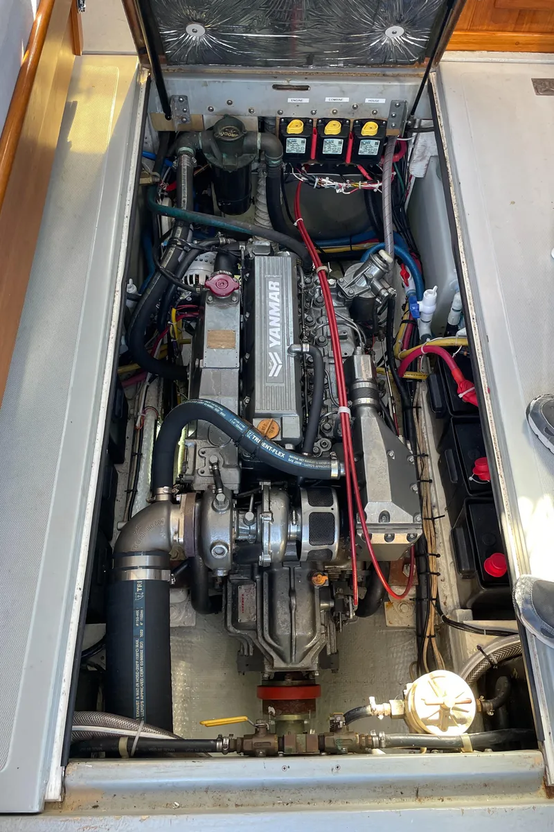 Slide: The Image of Engine compartment of a 1988 Ellis 28 boat, featuring a Yanmar engine. - 31