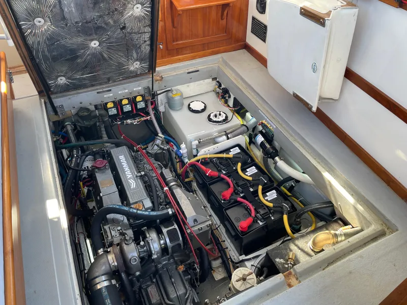 Slide: The Image of Engine compartment of a 1988 Ellis 28 boat, featuring Yanmar engine and battery setup. - 33