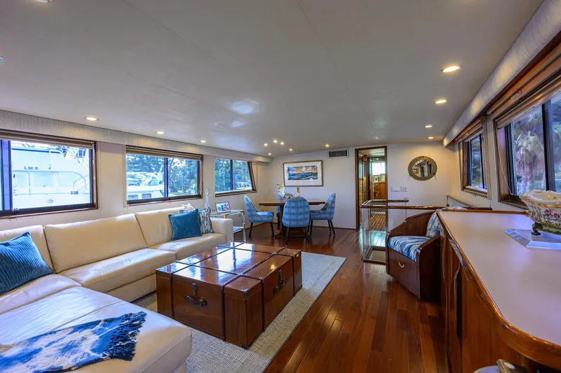 Slide: The Image of Luxurious interior of 1991 Hatteras 78 CMY yacht with elegant seating and wooden flooring. - 19