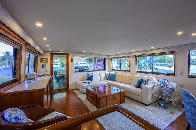 Slide: The Image of Luxurious interior of 1991 Hatteras 78 CMY yacht with elegant seating and large windows. - 2