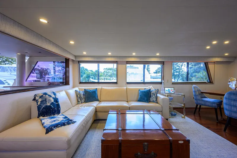 Slide: The Image of Luxurious interior of 1991 Hatteras 78 CMY yacht with elegant seating and large windows. - 20