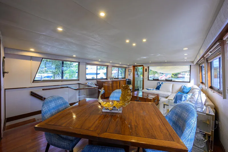 Slide: The Image of Luxurious interior of 1991 Hatteras 78 CMY yacht with elegant dining area and plush seating. - 26