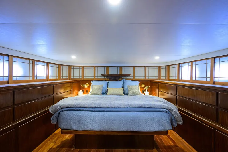 Slide: The Image of Luxurious bedroom interior on 1991 Hatteras 78 CMY yacht with elegant wood paneling. - 30
