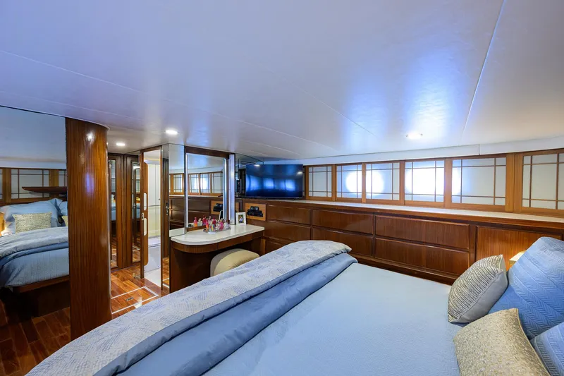 Slide: The Image of Luxurious bedroom interior of 1991 Hatteras 78 CMY yacht with elegant wood finishes. - 33