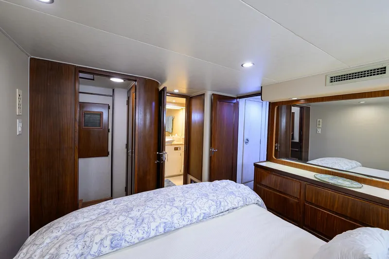 Slide: The Image of Luxurious bedroom interior on 1991 Hatteras 78 CMY yacht with wood accents and modern amenities. - 37