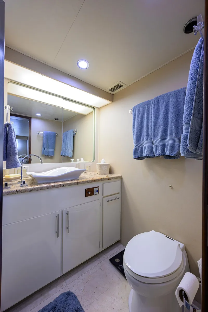 Slide: The Image of Bathroom interior of 1991 Hatteras 78 CMY yacht with modern fixtures and blue towels. - 38