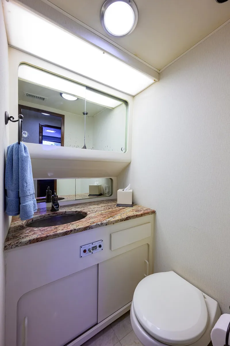Slide: The Image of Bathroom interior of 1991 Hatteras 78 CMY yacht with sink, mirror, and toilet. - 45
