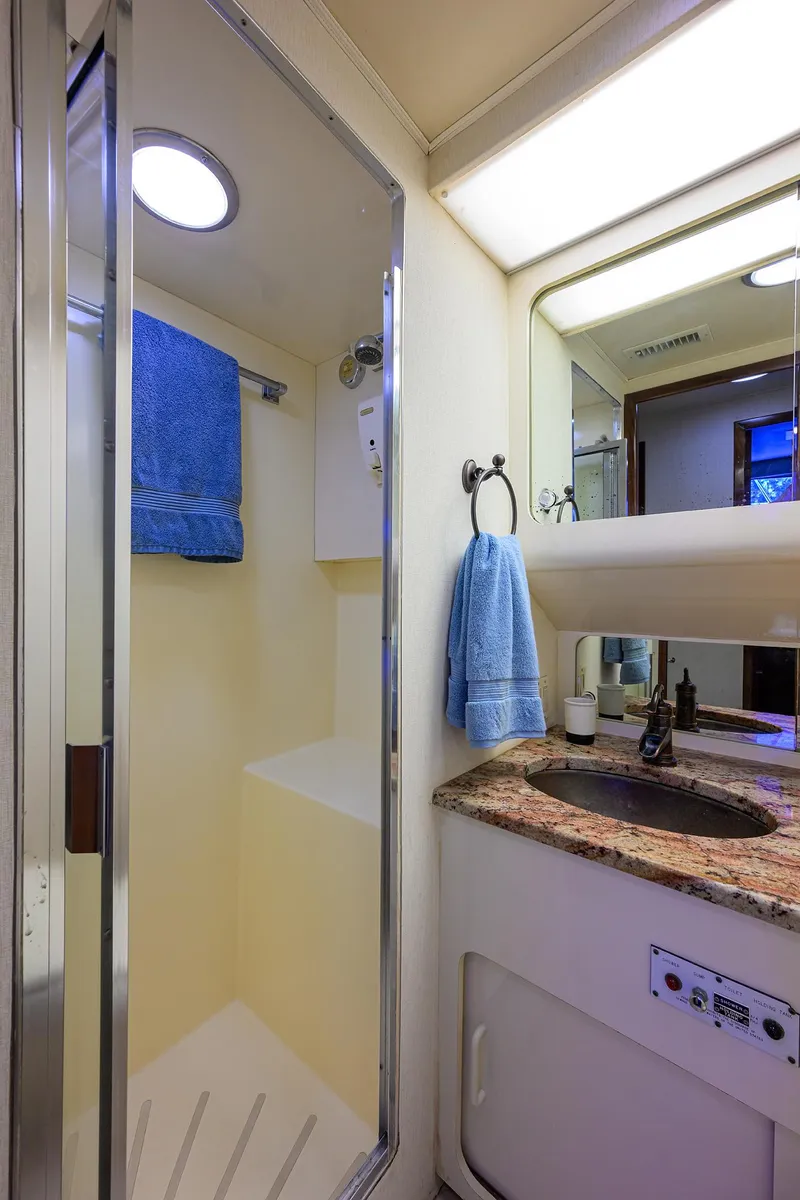 Slide: The Image of Bathroom interior of 1991 Hatteras 78 CMY yacht with shower and granite countertop. - 46