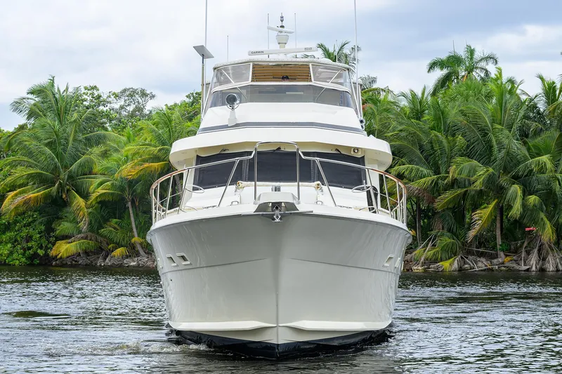 Slide: The Image of Front view of a 1991 Hatteras 78 CMY yacht on a tropical waterway. - 5