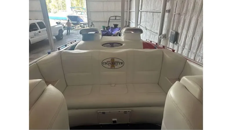 Slide: The Image of 2003 Cigarette 38 Top Gun boat interior with white seating in storage facility. - 10