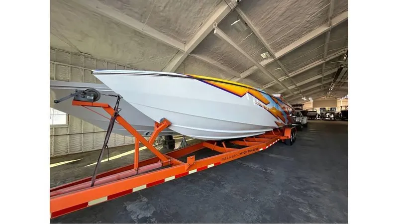 Slide: The Image of 2003 Cigarette 38 Top Gun boat on orange trailer in warehouse. - 3