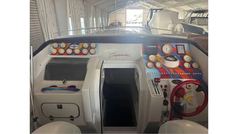 Slide: The Image of 2003 Cigarette 38 Top Gun boat dashboard with colorful gauges and controls. - 8
