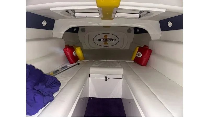 Slide: The Image of Interior of 2003 Cigarette 38 Top Gun boat with white seating and colorful accents. - 9