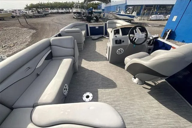 Slide: The Image of 2021 Bennington 22 SL pontoon boat interior with gray seating and steering console. - 11
