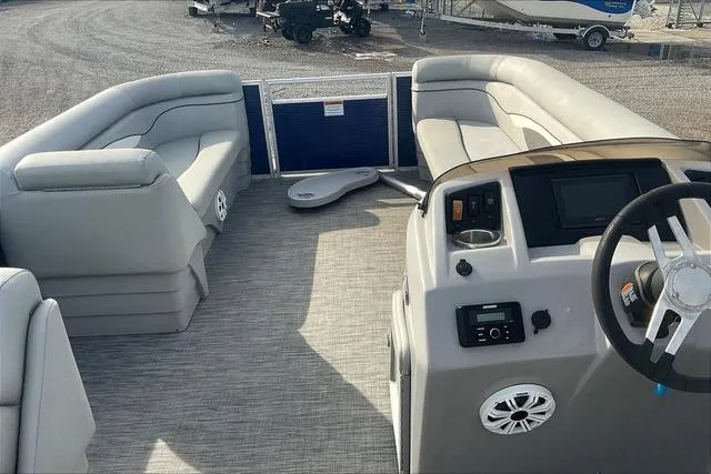 Slide: The Image of 2021 Bennington 22 SL pontoon boat interior with plush seating and modern dashboard. - 12