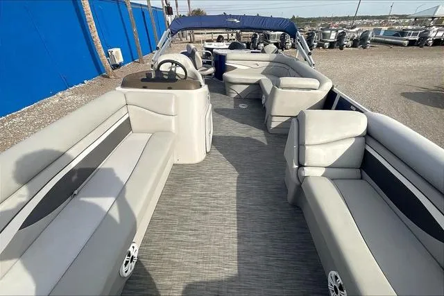 Slide: The Image of 2021 Bennington 22 SL pontoon boat interior with gray seating and steering console. - 13