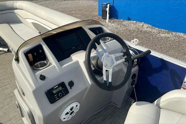 Slide: The Image of 2021 Bennington 22 SL boat dashboard with steering wheel and controls. - 14