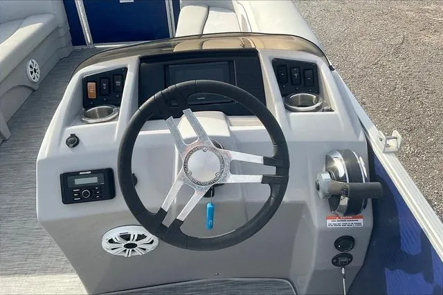 Slide: The Image of 2021 Bennington 22 SL boat dashboard with steering wheel and controls. - 15