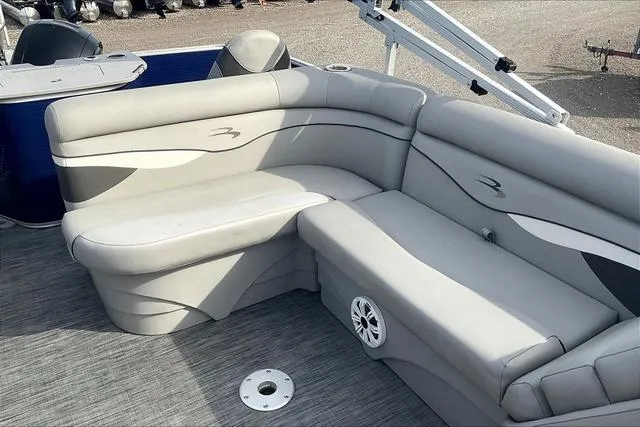 Slide: The Image of 2021 Bennington 22 SL boat interior with gray seating and speaker. - 22