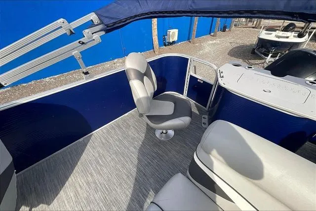 Slide: The Image of 2021 Bennington 22 SL boat interior with seating and blue accents. - 23
