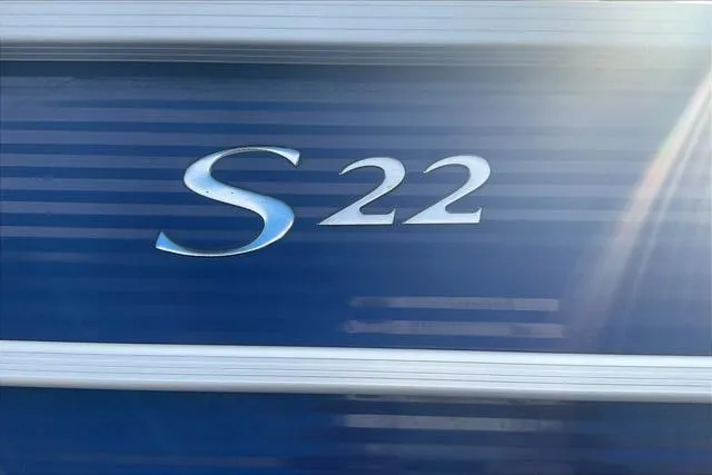 Slide: The Image of Bennington 22 SL 2021 boat emblem on blue background with sunlight. - 25