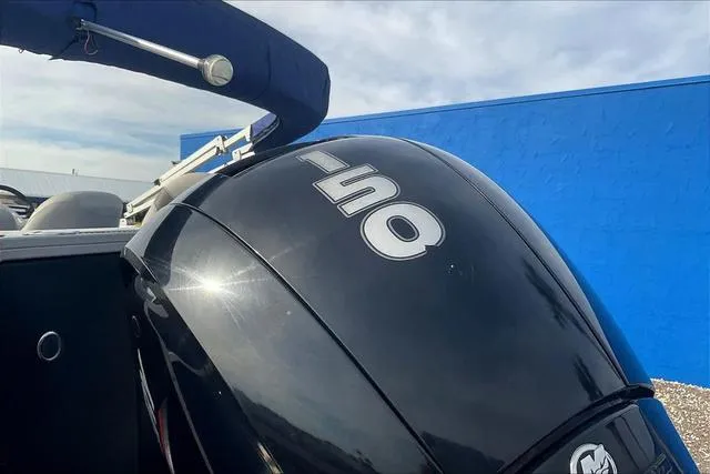 Slide: The Image of 2021 Bennington 22 SL boat with 150 horsepower engine, blue background. - 27