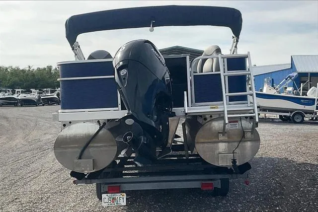 Slide: The Image of 2021 Bennington 22 SL pontoon boat on trailer, rear view with outboard motor. - 6