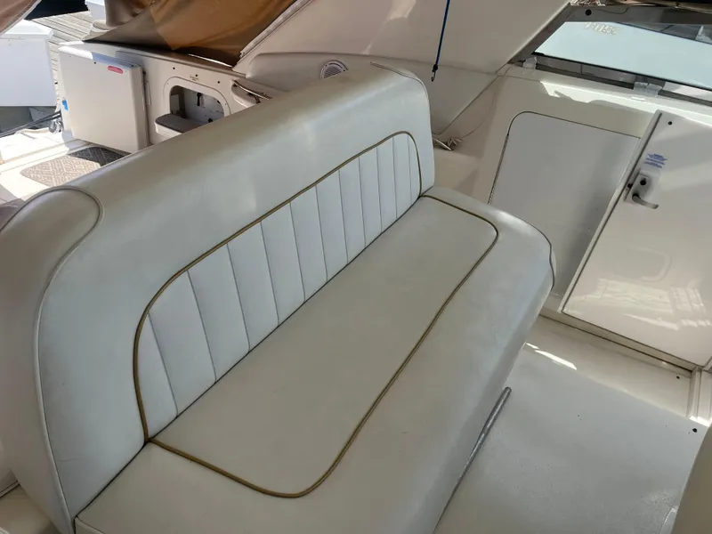 Slide: The Image of 1996 Sea Ray 450 Sundancer interior with white leather seating and storage compartments. - 11