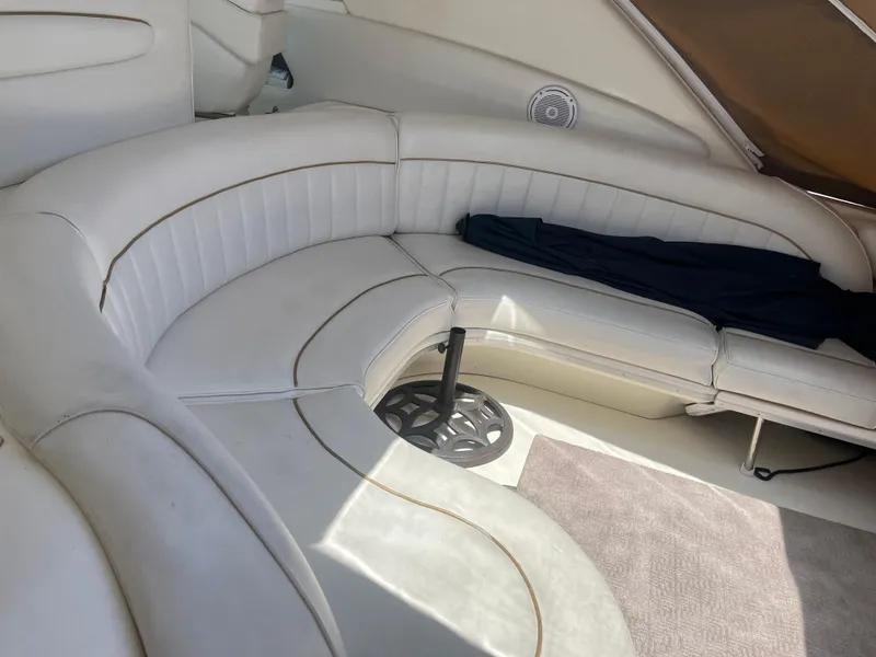 Slide: The Image of Interior seating of 1996 Sea Ray 450 Sundancer yacht, featuring white leather upholstery. - 12
