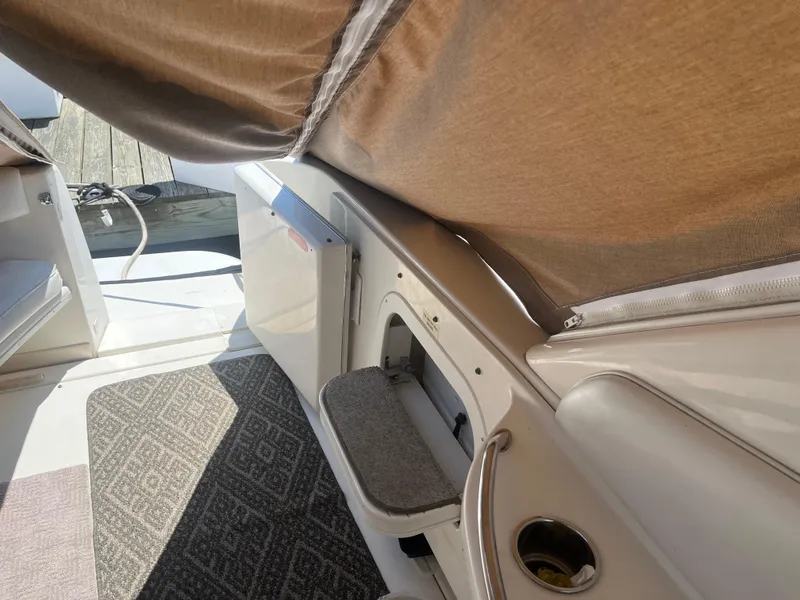 Slide: The Image of 1996 Sea Ray 450 Sundancer interior with carpeted floor and seating area. - 13