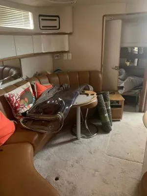 Slide: The Image of Interior of 1996 Sea Ray 450 Sundancer yacht with leather seating and table. - 15
