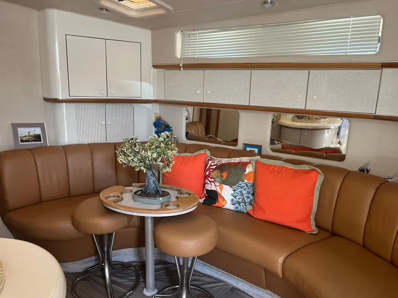 Slide: The Image of Interior of 1996 Sea Ray 450 Sundancer with leather seating and decorative pillows. - 21