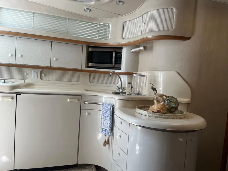 Slide: The Image of Interior of 1996 Sea Ray 450 Sundancer yacht kitchen with modern amenities. - 22