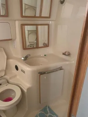 Slide: The Image of Bathroom interior of 1996 Sea Ray 450 Sundancer yacht, featuring sink and toilet. - 24