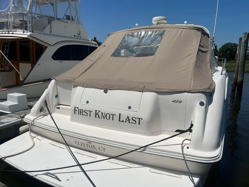 Slide: The Image of 1996 Sea Ray 450 Sundancer docked, covered, with "First Knot Last" name, Clinton, CT. - 3