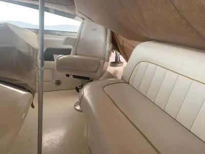 Slide: The Image of Interior view of 1996 Sea Ray 450 Sundancer with beige seating and covered helm. - 8