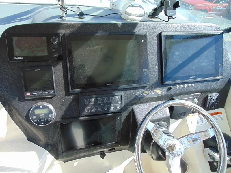 Slide: The Image of 2011 Hydra-Sports 3000VX Express dashboard with multiple navigation screens and controls. - 18