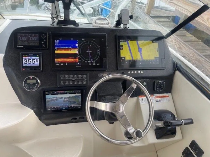Slide: The Image of 2011 Hydra-Sports 3000VX Express dashboard with navigation screens and steering wheel. - 2