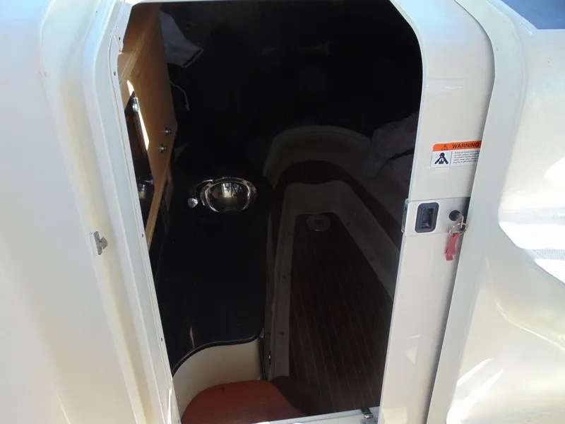 Slide: The Image of 2011 Hydra-Sports 3000VX Express cabin interior with wood flooring and compact kitchenette. - 20