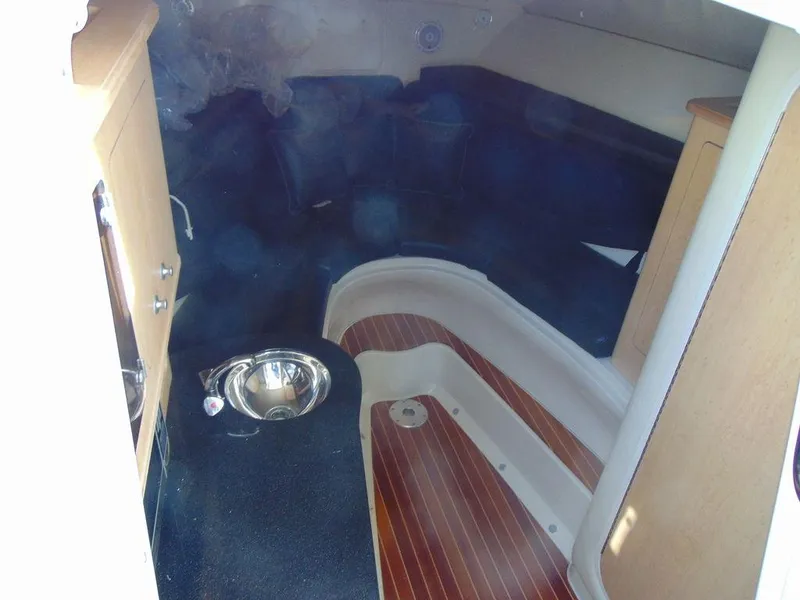 Slide: The Image of 2011 Hydra-Sports 3000VX Express cabin interior with wood flooring and compact kitchenette. - 21
