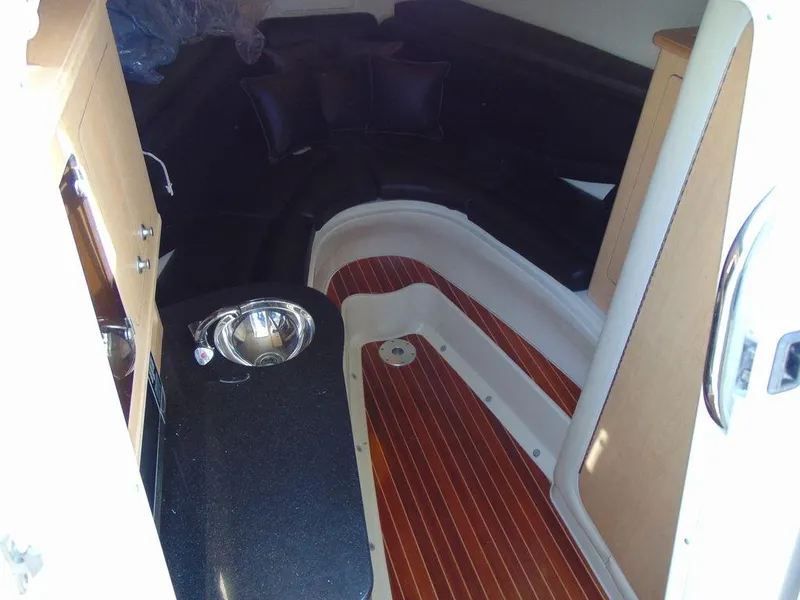 Slide: The Image of 2011 Hydra-Sports 3000VX Express cabin interior with wood flooring and kitchenette. - 23