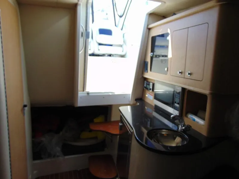 Slide: The Image of Interior of 2011 Hydra-Sports 3000VX Express boat with kitchenette and seating area. - 28