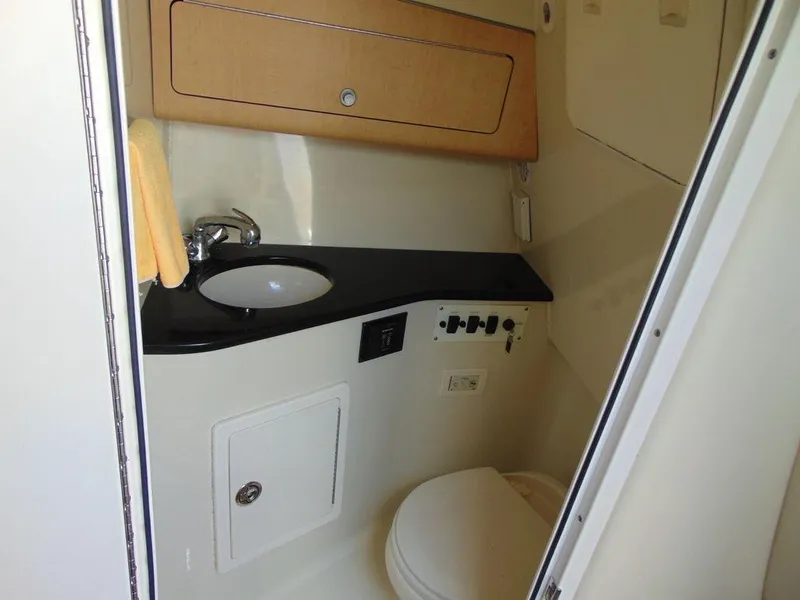 Slide: The Image of 2011 Hydra-Sports 3000VX Express boat bathroom with sink, toilet, and storage cabinet. - 30