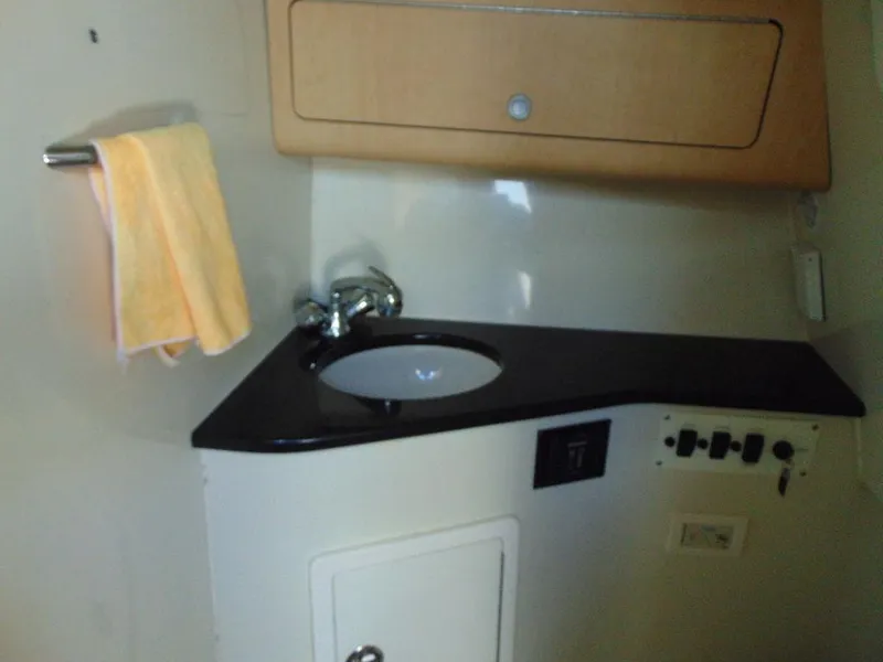 Slide: The Image of 2011 Hydra-Sports 3000VX Express boat interior with sink and towel. - 32