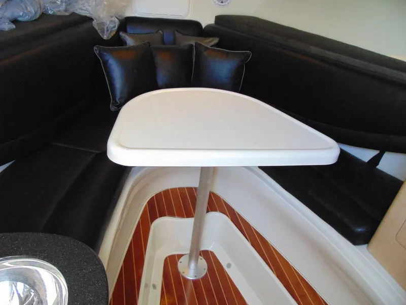 Slide: The Image of 2011 Hydra-Sports 3000VX Express cabin interior with table and black seating. - 33