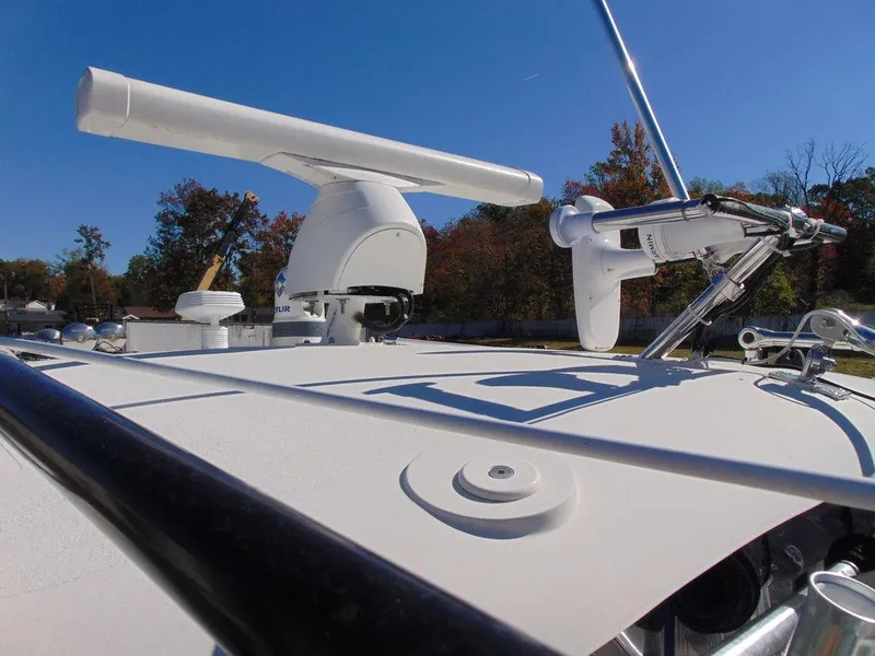 Slide: The Image of 2011 Hydra-Sports 3000VX Express boat radar and equipment on deck under clear blue sky. - 36