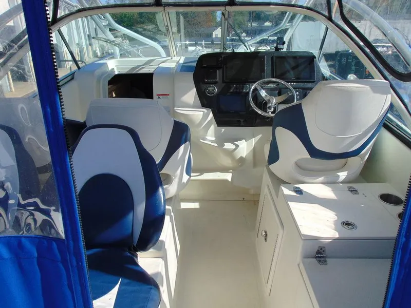 Slide: The Image of 2011 Hydra-Sports 3000VX Express boat interior with blue and white seating and modern dashboard. - 9