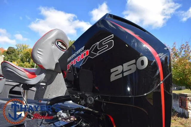 Slide: The Image of 2024 Triton 206 Allure boat with Mercury Pro XS 250 engine, outdoor setting. - 11